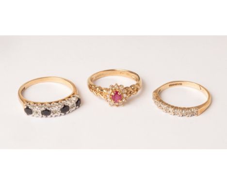 A 9ct gold diamond and sapphire ring, the four sapphires set with three small diamonds, size N, a 9ct gold diamond and ruby c