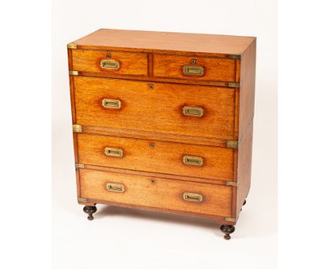 An early Victorian teak and brass bound military chest with countersunk brass handles, in two sections, the top fitted two lo