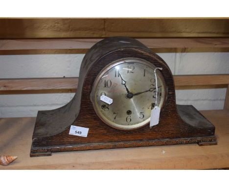 An oak cased mantel clock