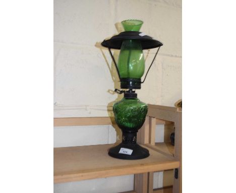 A green glass oil lamp