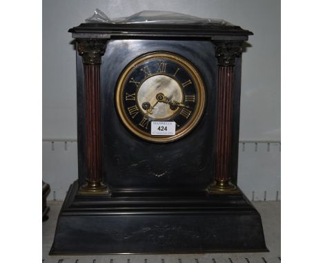 An architectural mantel clock in black marble, with visible escapement and French movement
