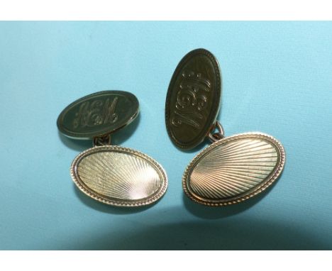 A pair of 9 carat hallmarked gold oval cufflinks, monogrammed and engine turned, 8.4gm