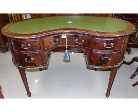 A mahogany reproduction Regency style desk, kidney shaped with kneehole, inset green leather top, 5 drawers, blind fret brack