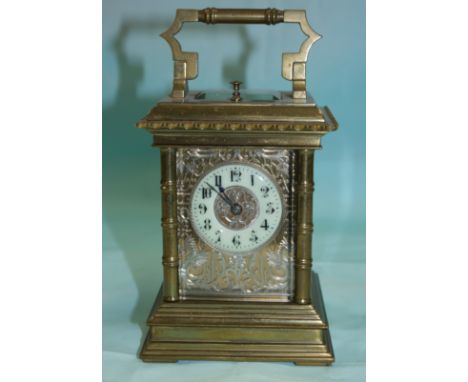 A 19th century brass carriage clock with turned ribbed pillars and double stepped base, ornate silver and brass pierced and c