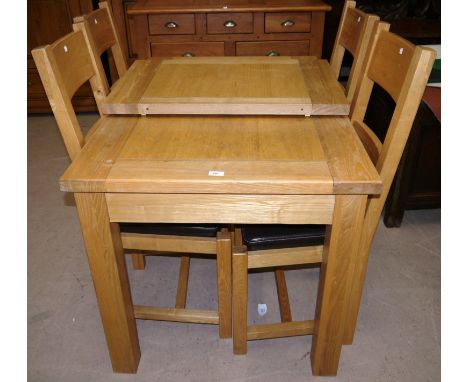 A modern light oak dining suite comprising extending rectangular table and 4 ladder back chairs