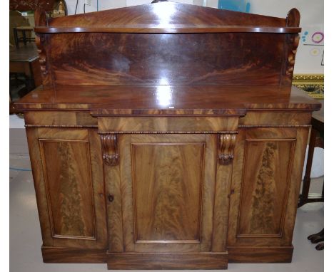 A William IV breakfront figured mahogany chiffonier with raised scroll back and serpentine shelf on scroll brackets, 3 cupboa