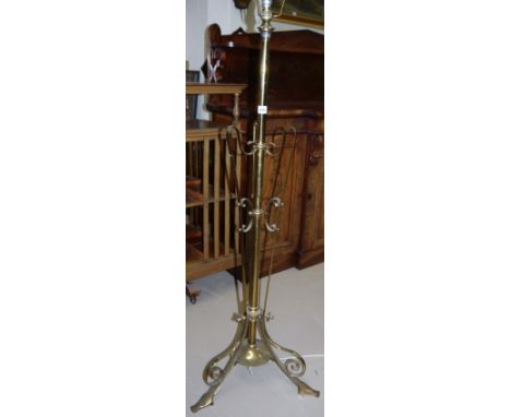 An Art Nouveau brass standard lamp on trefoil base (converted)