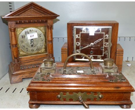 An Edwardian oak architectural mantel clock; a 1930's chiming mantel clock; a Victorian oak inkwell with brass mounts