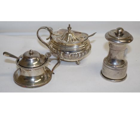 A silver capstan shaped pepper grinder, London 1900 (Peugeot mechanism); a similar waisted and gadrooned mustard with blue gl