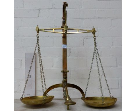 A pair of 19th century brass balance scales by Salter, with twin brass pans and pedal operated lifting mechanism