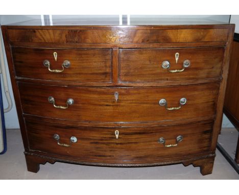A Victorian mahogany bow front chest with boxwood inlay, inlaid crest of Britannia to front, 2 long and 2 short drawers with 