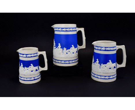 Set of Three Copeland Spode Graduated Blue and Cream Stoneware Jugs, each showing a panoramic hunting scene in relief, with l