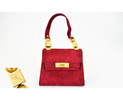 A Vintage Miniature Suede Box Bag Small top handle structured bag in claret suede finished with matte gold tone hardware. Fla