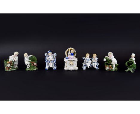Conta and Boehme Dressing Table Fairing Box and six further figural fairings, the box with the figure of a small girl playing