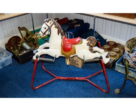 A Retro Child's  Rocking Horse 1950's/60's rocking horse in cast metal on sprung base finished in traditional red, white and 