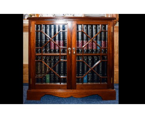 A Small Mahogany Bookcase Features astral glazed doors raised on bracket feet. Height 31 inches, width 33 inches, depth 13 in