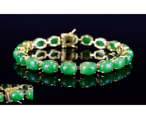 Chinese Green Jade Tennis Bracelet, 40cts of oval cut cabochons of green jade, set in a single row in gold vermeil and silver