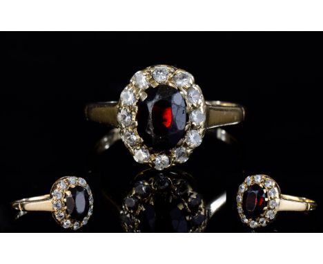 9ct Gold Set Diamond and Ruby Cluster Ring. Flowerhead Setting, The Central Ruby Surrounded by 12 Small Diamonds. Fully Hallm