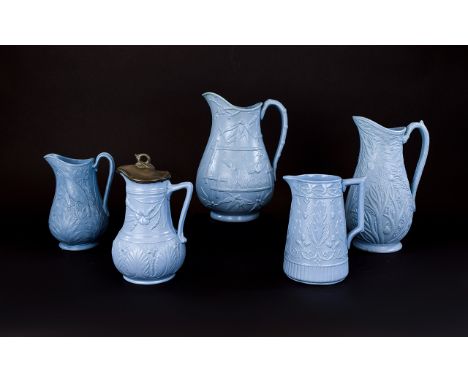 Five Various Aesthetic Period Blue Moulded Jugs, the largest decorated with bamboo and birds in flight in a typical example o