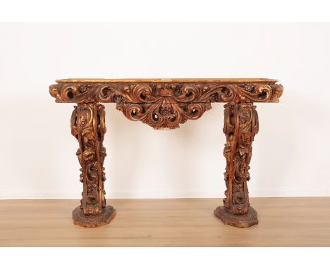 A ROCOCO STYLE GILTWOOD CONSOLE TABLE20th century, ornately decorated with rocaille and floral motifs throughout, lacking top