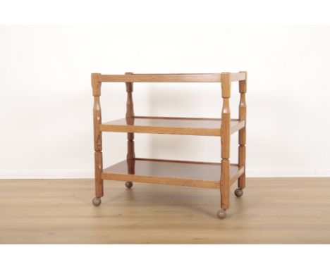 COLIN 'BEAVERMAN' ALMACK (1930-1996): AN ENGLISH OAK TEA TROLLEY1960's, of two-tier form with carved supports ending in casto