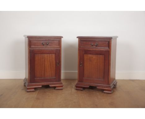 A PAIR OF MAHOGANY BEDSIDE CABINETSeach with a single short drawer over a cupboard, on ogee bracket feet, 66.5cm high x 45cm 