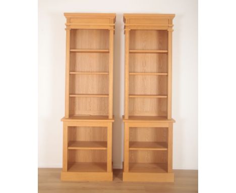 A PAIR OF LIGHT OAK BREAKFRONT BOOKCASESof 19th century design with moulded cornices, each fitted four shelves, each 250cm hi