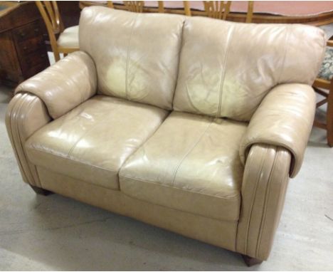 Beige leather 2 seater sofa.