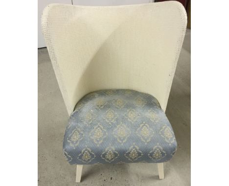 A vintage Lloyd Loom style curved back bedroom chair with blue upholstery and sprung seat