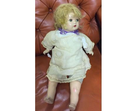 A vintage doll c1940s with composite head & limbs and cloth body. Blue open/shut eyes with lashes. Some fine cracks to face.