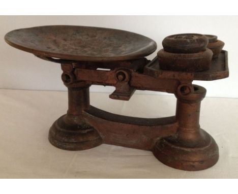A vintage set of weighing scales with shallow copper bowl. With weights.
