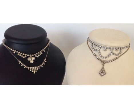 4 vintage costume necklaces, each set with white stones.