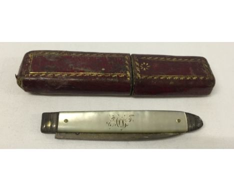 A vintage silver bladed fruit knife with mother of pearl handle in red leather case.