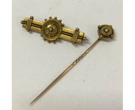 A Victorian 15ct gold celtic style brooch with a 15ct gold stick pin, the head bearing a seed pearl.