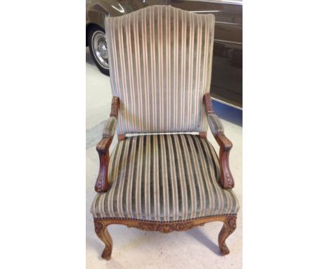 Vintage carved green striped upholstered armchair.