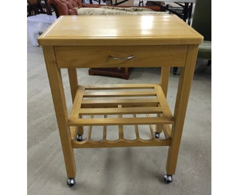 A pine kitchen utlity trolley with wine rack and shelf. 64 x 46cm top and 85cm tall.