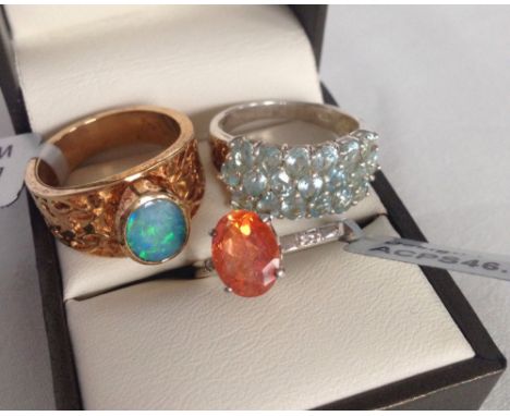 3 silver rings set with coloured stones to include blue topaz, mystic topaz and boulder opal. One gold plated.