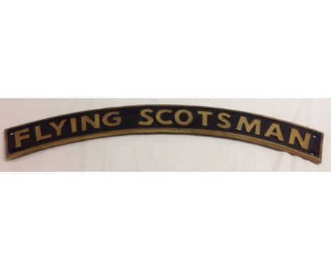 A reproduction cast iron 'Flying Scotsman' curved steam engine name plate, 90cm long.