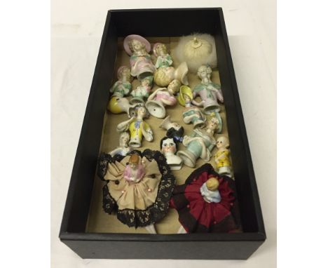 A box of 17 vintage bisque half dolls and head/shoulder dolls, and a powder puff pin doll base. Includes 2 dolls dressed with