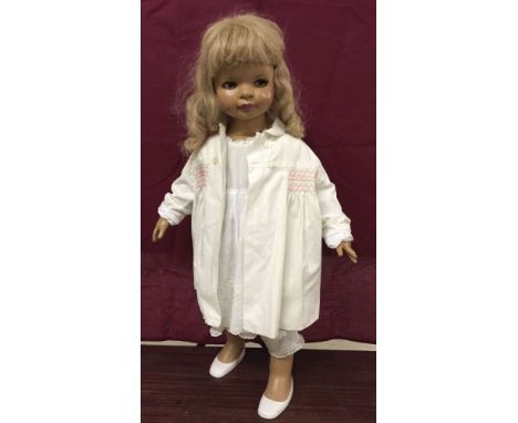 A c1970s vintage girl shop mannequin. Measures 74cm tall. Dressed and with hair wig.
