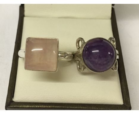 2 silver rings. One set with rose quartz size R, the other with an amethyst cabouchon. Size L½.