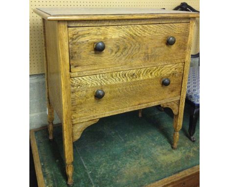 A light oak 2 drawer chest of drawers with octagonal carved feet. 71cm wide.