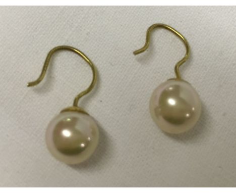 A pair of faux pearl earrings on 9ct gold wires.