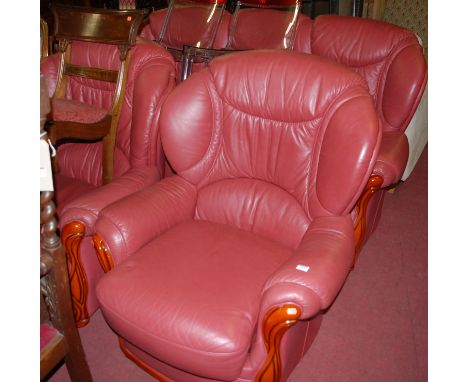 A modern walnut framed and red leather upholstered three piece suite, comprising three seater sofa and pair of armchairs