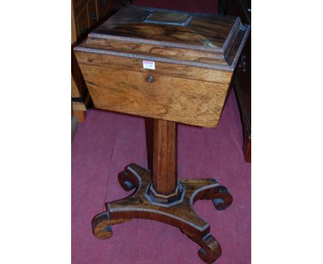 A Regency rosewood pedestal teapoy, having well-fitted four caddy interior, raised on quatraform platform with gadrooned edge