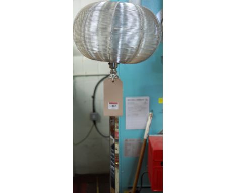 An Art Deco chrome standard lamp, having replacement wirework shade over hexagonal column to lozenge shaped ebonised wood bas