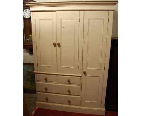 A modern cream painted pine wardrobe, the twin upper doors over two short and two long drawers, flanked by a single long door