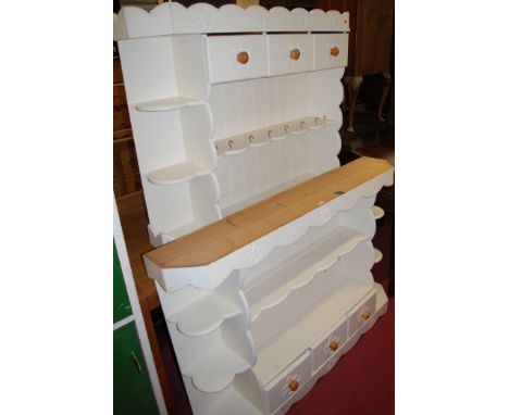 A white painted pine open hanging wall shelf with three short drawers, together with one other similar example (2)