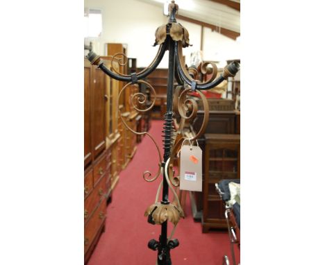 A late Victorian black painted wrought iron three light standard lamp
