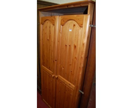 A modern pine double door wardrobe, together with a modern pine rectangular wall mirror (2)